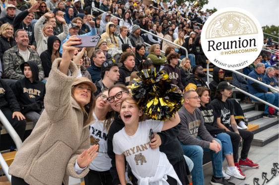 A group poses for a selfie during a football game at Bryant University.