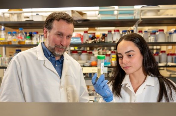 Biology Professor Chris Reid views test tubes with a student in one of Bryant's laboratories. 