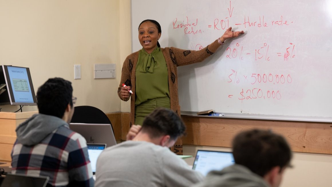 Bryant Assistant Professor of Accounting Muni Kelly teaching in a classroom